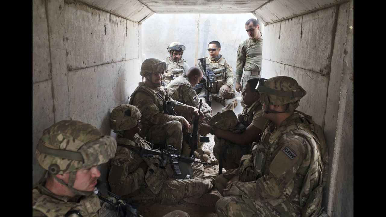U.S. military personnel take cover in a bunker after a mortar alarm was sounded at a coalition air base in Qayyara on Friday, October 28. 