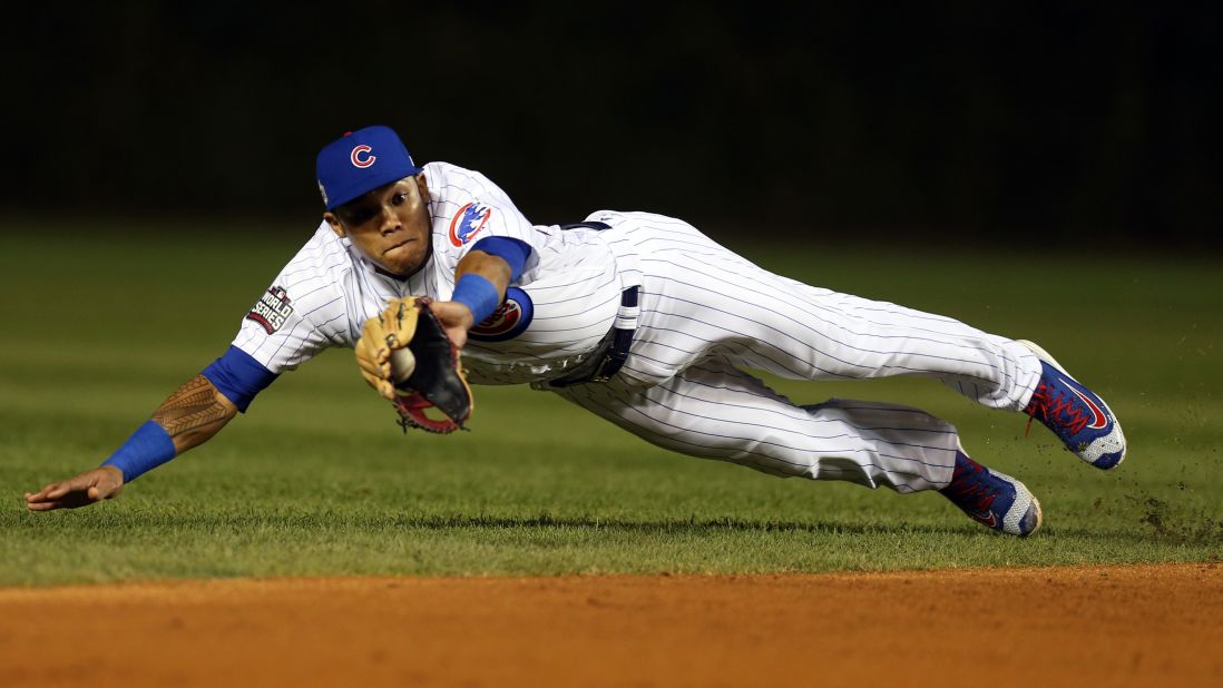 Addison Russell of the Cubs makes a diving catch for an out during the third inning in Game 3.