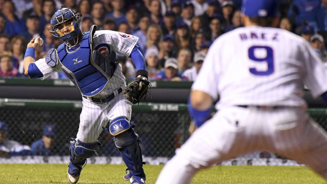 Willson Contreras of the Cubs throws to second baseman Javier Baez for an out on a bunt attempt by Indians starting pitcher Josh Tomlin in Game 3.