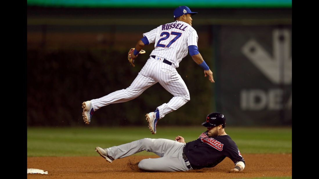 Addison Russell of the Cubs turns an inning-ending double play in the fifth inning in Game 3.