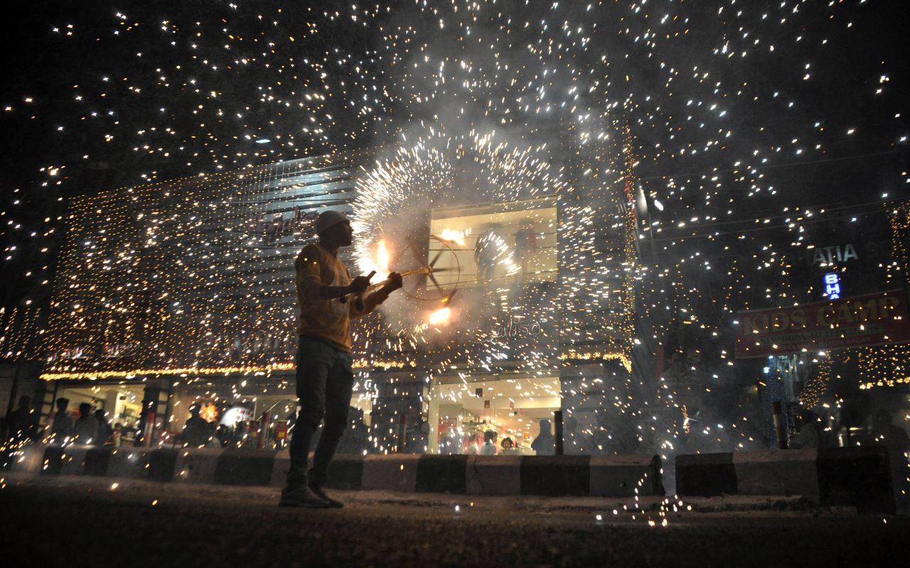 A man joins in a fireworks display at a marketplace in Jammu, India, on the eve of a Diwali festival on Thursday, October 27.