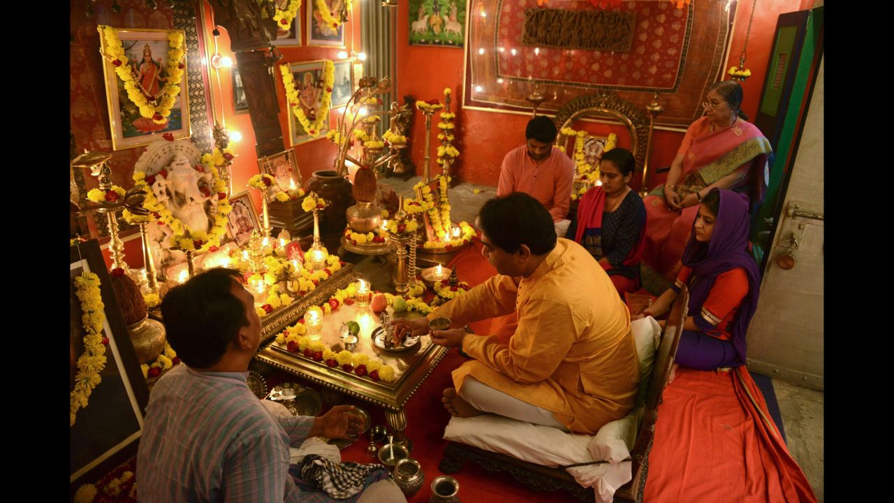 Umang Hutheesing, center, participates in a worship of wealth ceremony at Sheth Hutheesing Haveli in Ahmedabad, India, on Friday, October 28.