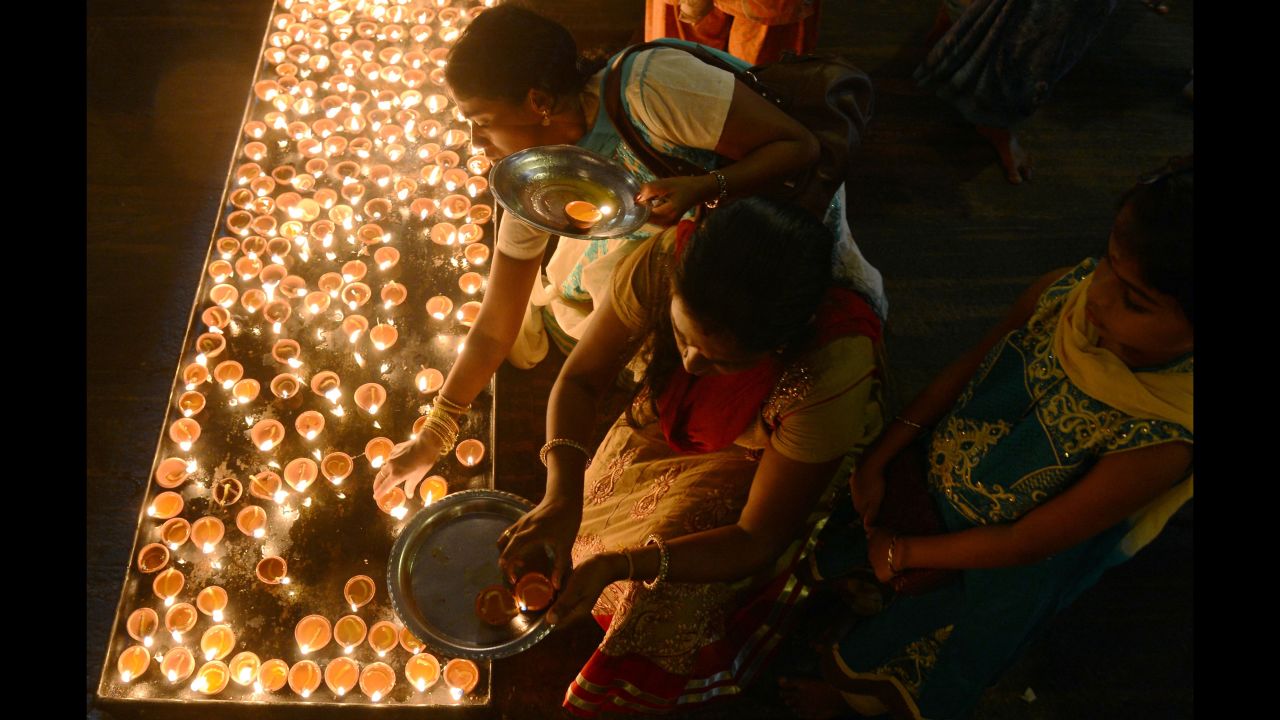 Sri Lankan Hindus light oil lamps during Diwali at a temple in Colombo on October 29. 