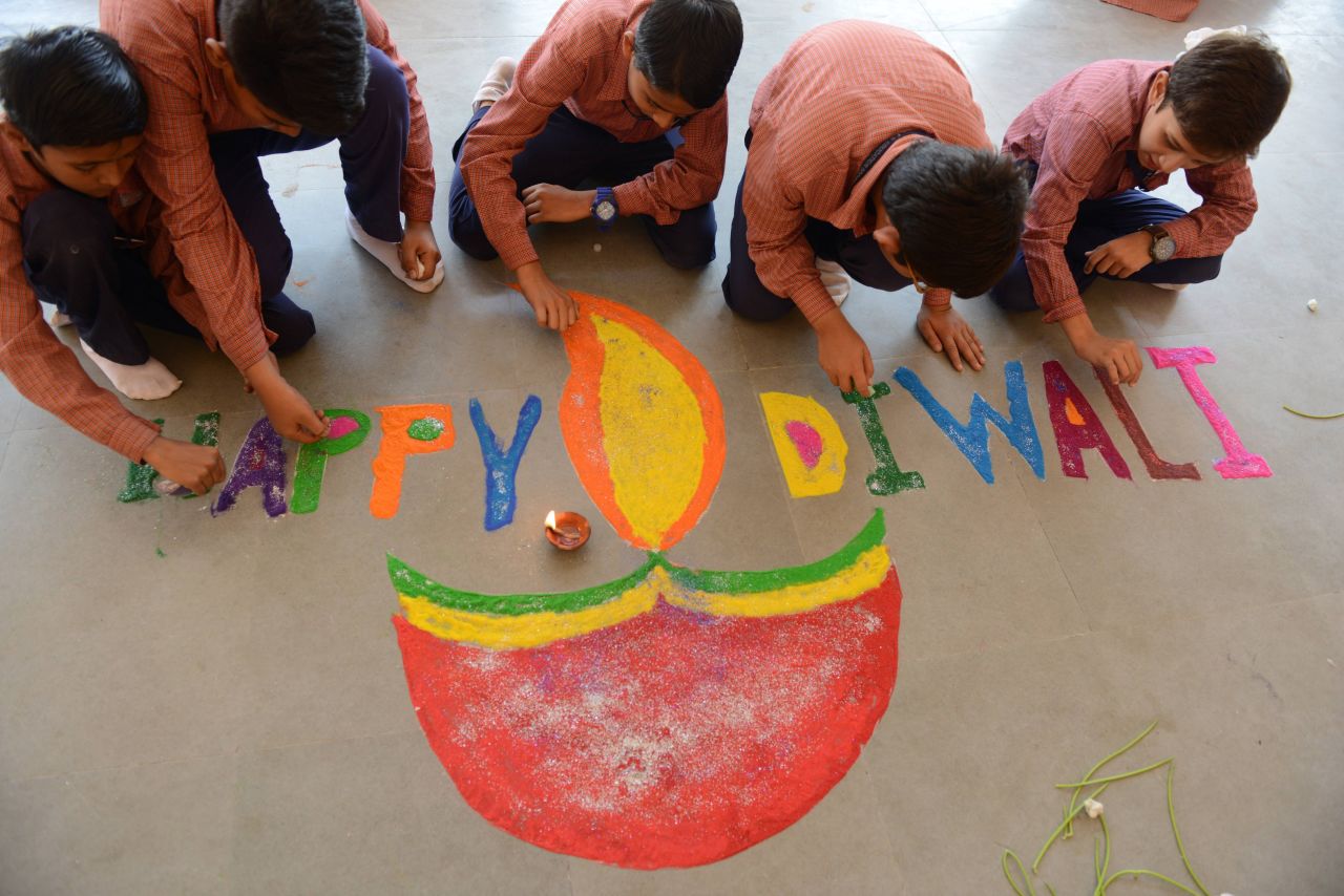 Muslim students prepare a colorful Rangoli with an oil lamp illustration at a high school in Ahmedabad, India, on October 27.