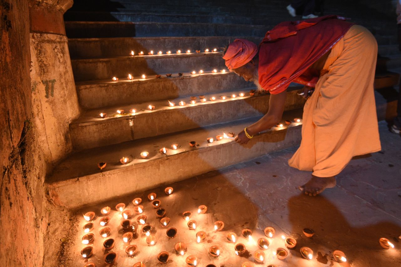 A sadhu, or holy man, lights oil lamps on the banks of the Ganges River during Diwali celebrations in Rishikesh, India October, 29.