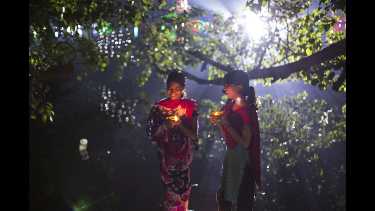 Bangladeshi girls light oil lamps ahead of the Diwali festival in Dhaka on October 29.
