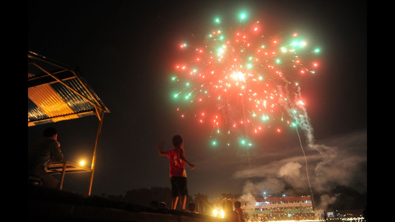 A child watches fireworks at the Madan Mohan Malviya Stadium  in Allahabad, India, on the eve of the Hindu festival of Diwali on October 29.