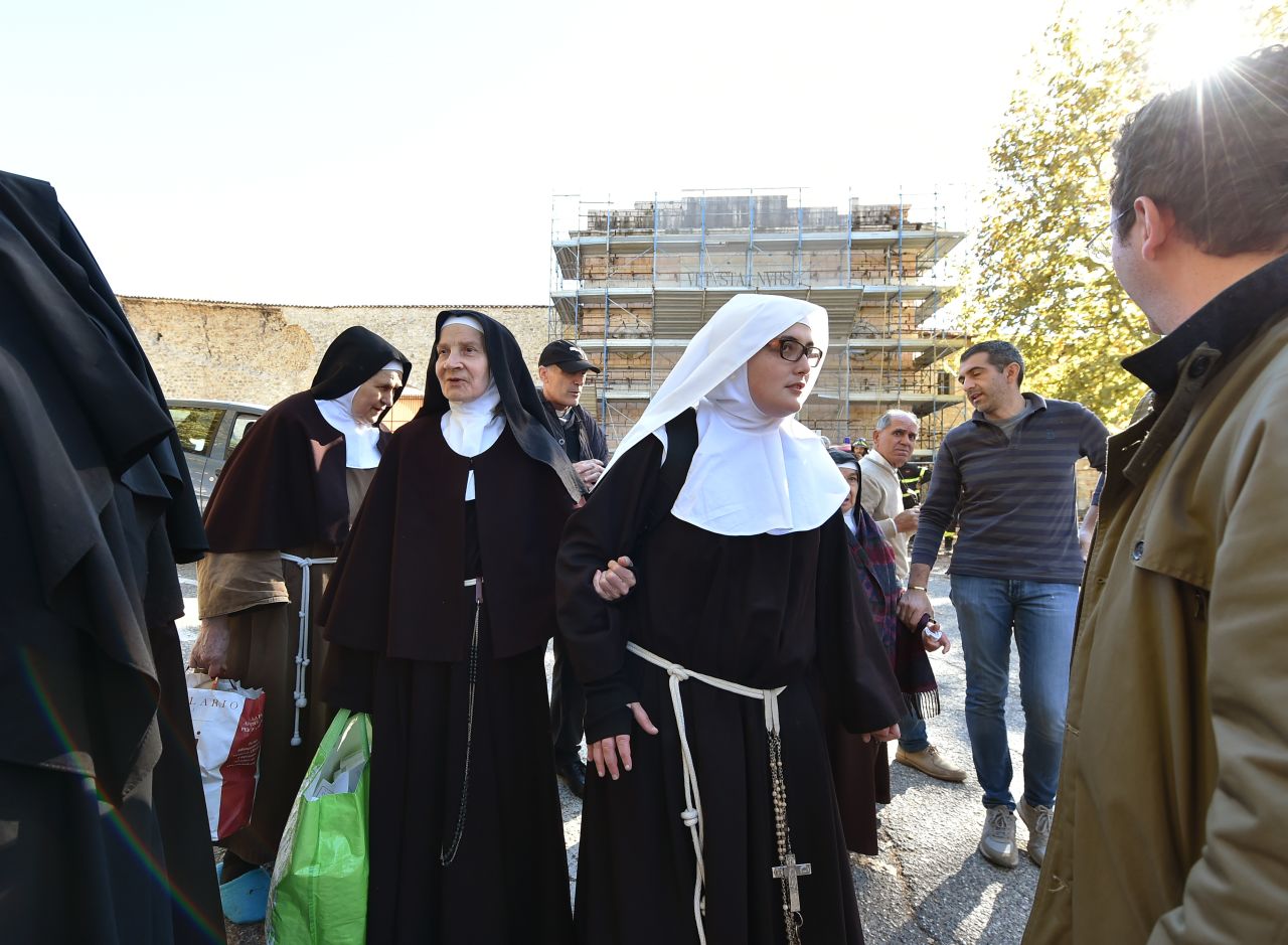 A group of nuns leave the center of Norcia on October 30 after being rescued earlier. Residents ran onto the streets in a panic when the quake struck in the  morning.