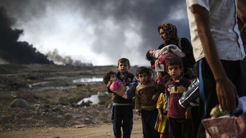 Iraqi families displaced by the ongoing operation to retake the city of Mosul from ISIS are seen near Qayyarah, south of the city, on October 29, 2016.