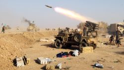 Shiite fighters from the Hashed al-Shaabi launch missiles on the village of Salmani, south of Mosul, on October 30, 2016 during the ongoing battle against Islamic State to liberate the city of Mosul.