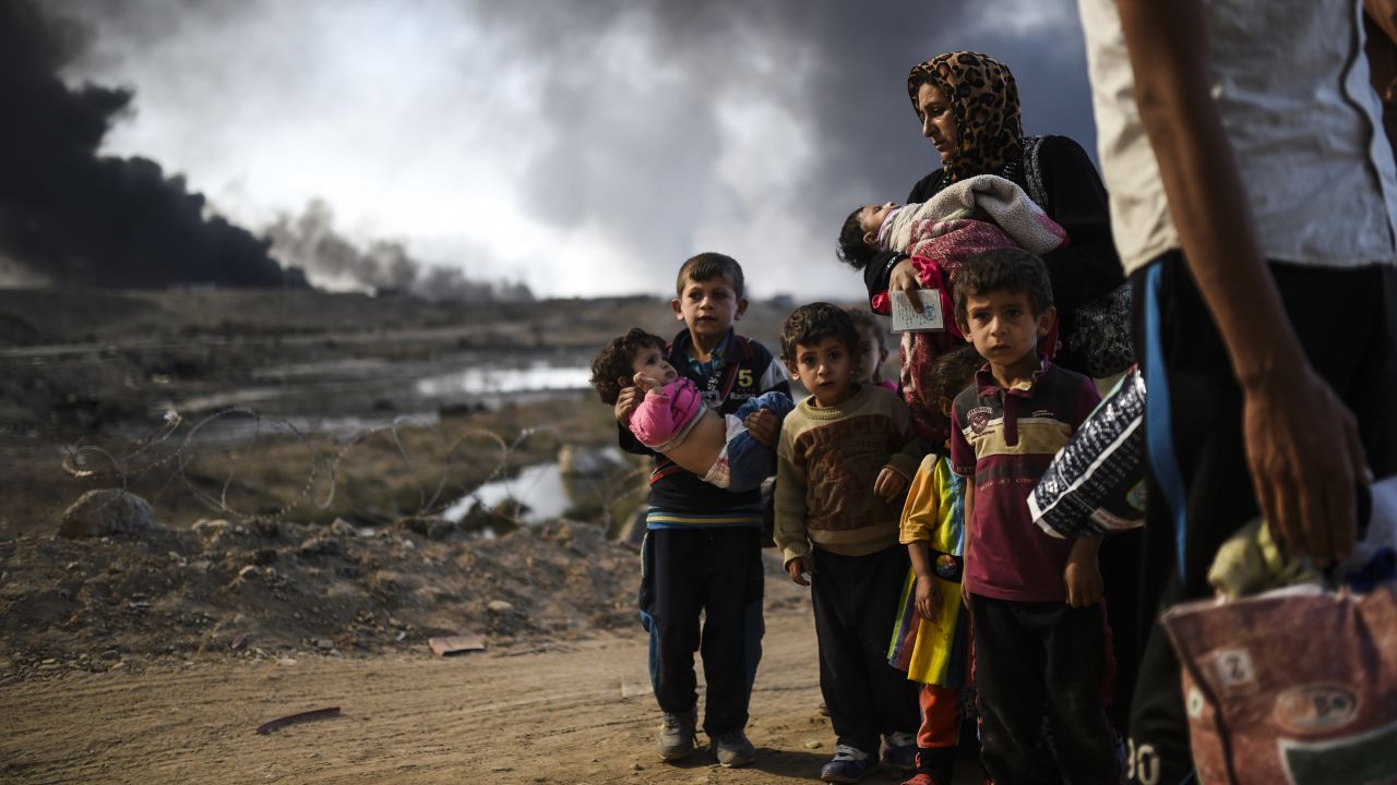 Iraqi families displaced by the ongoing operation to free Mosul are seen near Qayyarah, south of the city, on Saturday.