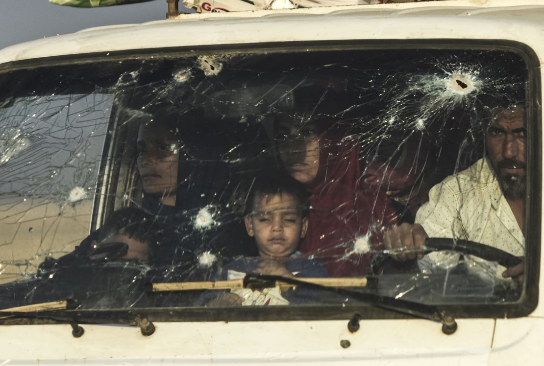 Iraqi families displaced by fighting between Iraqi forces and ISIS flee their home Saturday.