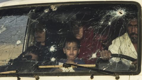 Iraqi families displaced by fighting between Iraqi forces and ISIS flee their home Saturday.