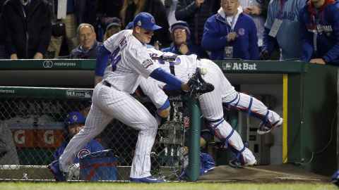Chicago Cubs first baseman Anthony Rizzo (44) reaches for a ball bounced off from catcher David Ross who was trying to catch a foul ball hit by Cleveland's Carlos Santana during the second inning of Game 5.