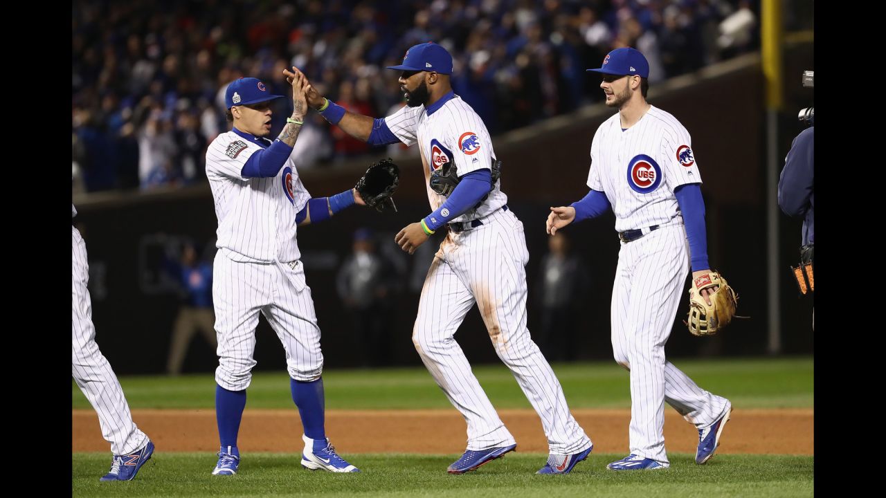 Javier Baez, left, Jason Heyward, center, and Kris Bryant of the Cubs celebrate after Game 5. 