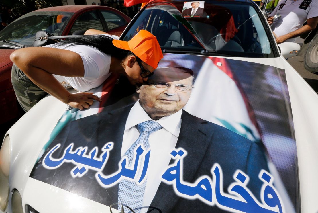 A woman kisses a portrait of Michel Aoun as revelers celebrate Monday on the outskirts of Beirut. 