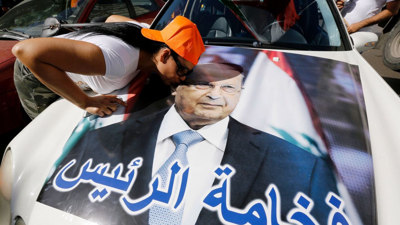A woman kisses a portrait of Michel Aoun as revelers celebrate Monday on the outskirts of Beirut.