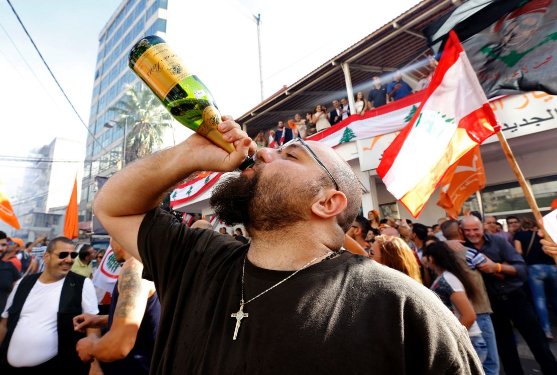 A man drinks champagne during a celebration marking Lebanon's first president in 29 months.