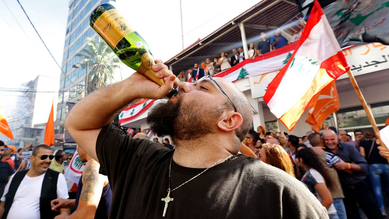 A man drinks champagne during a celebration marking Lebanon's first president in 29 months.