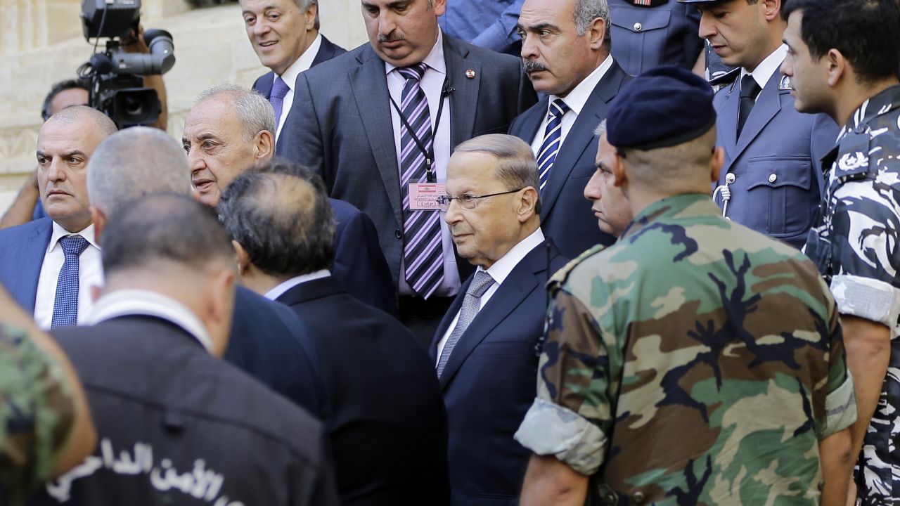 Michel Aoun, center wearing glasses, leaves parliament after a voting session Monday in Beirut.