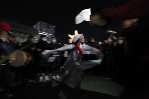 A protester satirizes President Park's relationship with Choi Soon-Sil, wearing a costume of a shaman during the Saturday night protest.