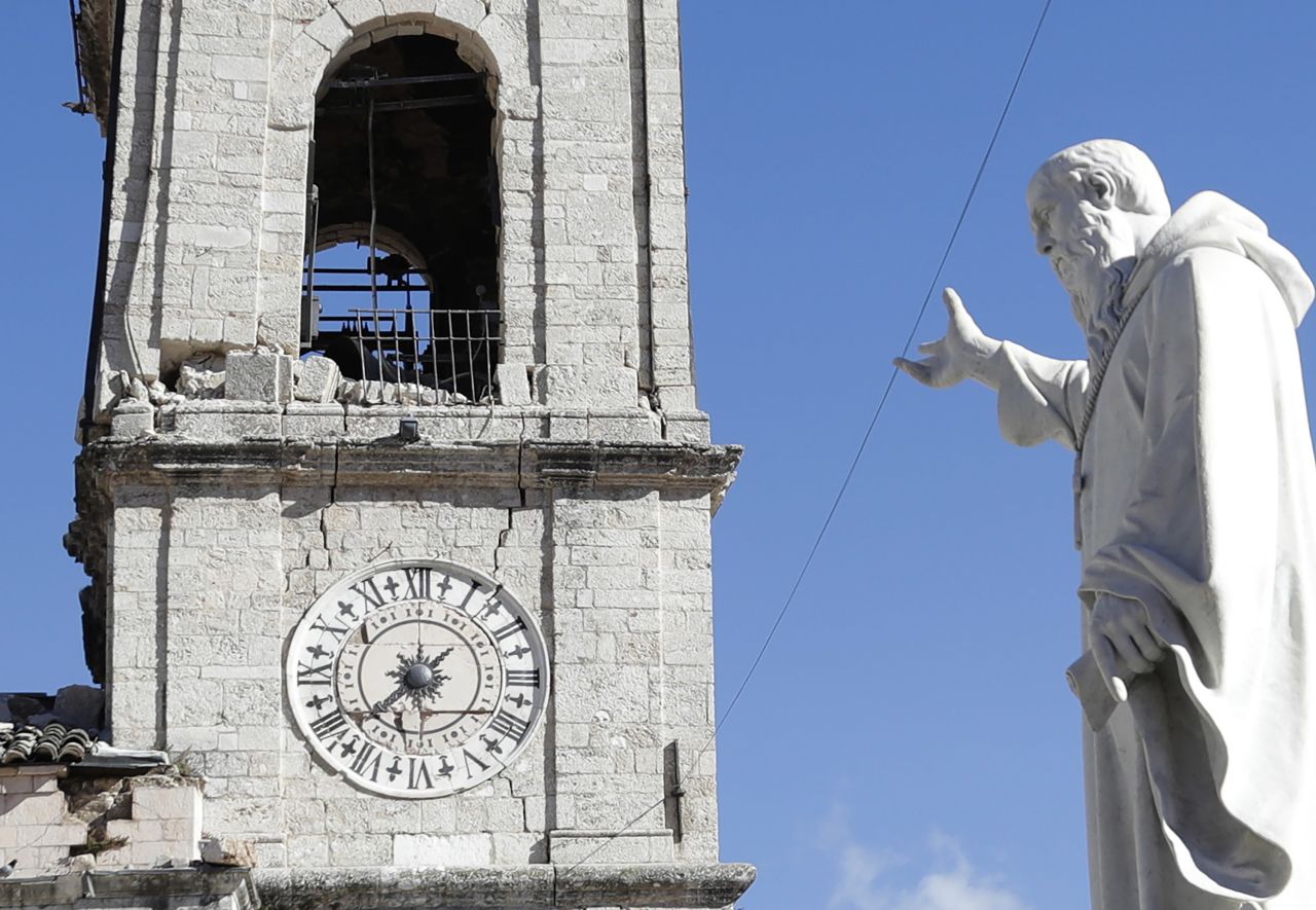 A statue of St. Benedict remains standing in front of the damaged bell tower in the town of Norcia on October 31.