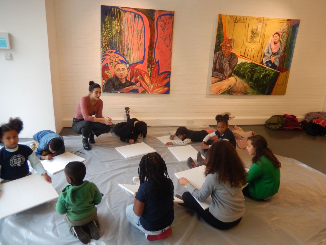 Children of market traders enjoy an art class. 