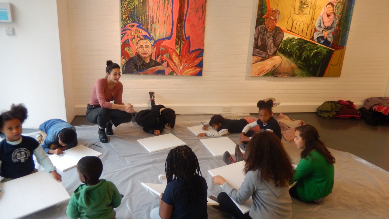 Children of market traders enjoy an art class. 