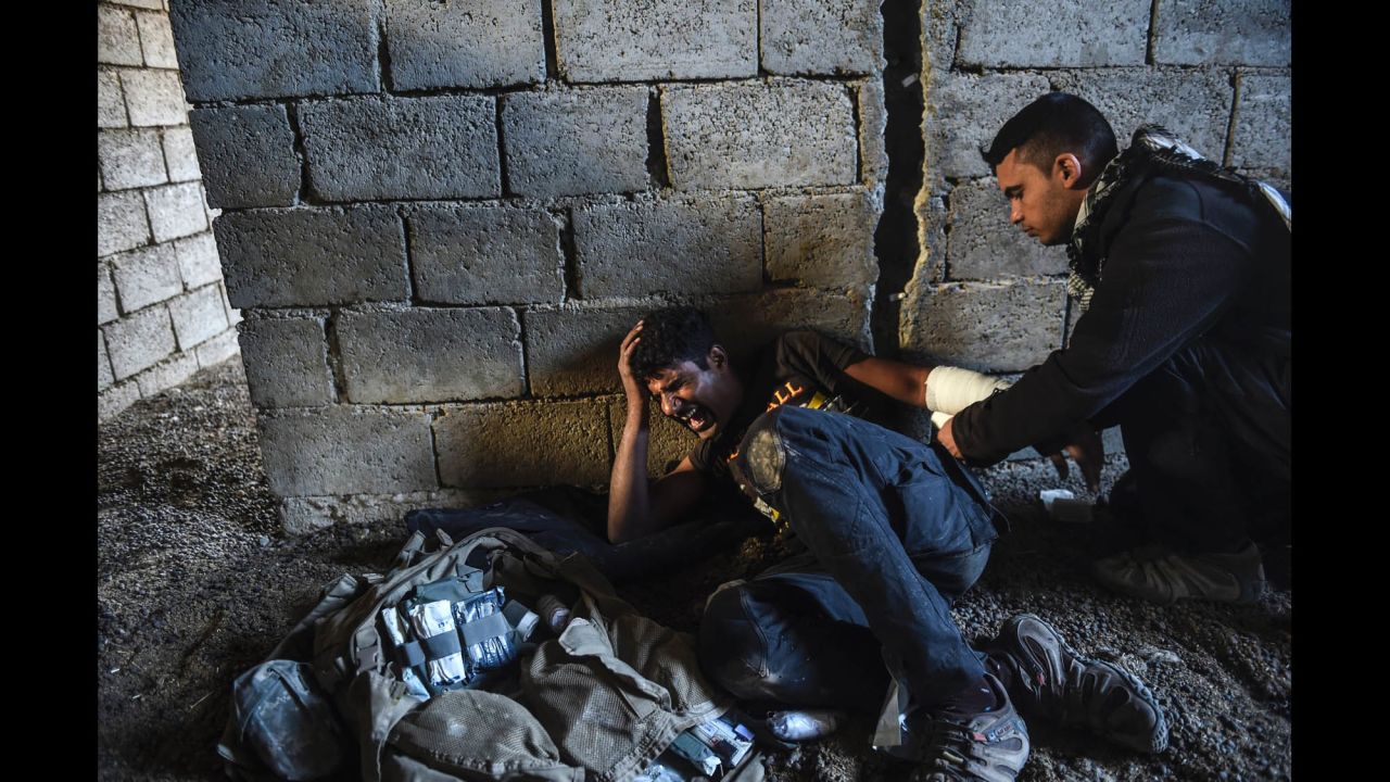 An Iraqi soldier receives treatment after being injured during clashes with ISIS fighters near Bazwaya on October 31.