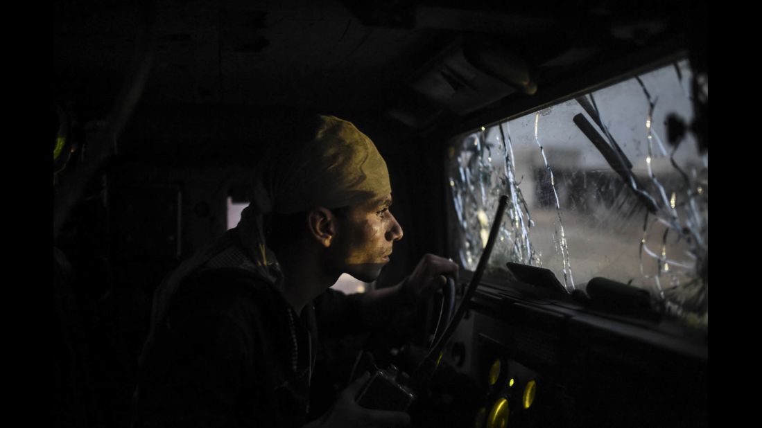 An Iraqi soldier navigates through a shattered windshield as coalition forces advance on Bazwaya on October 31.