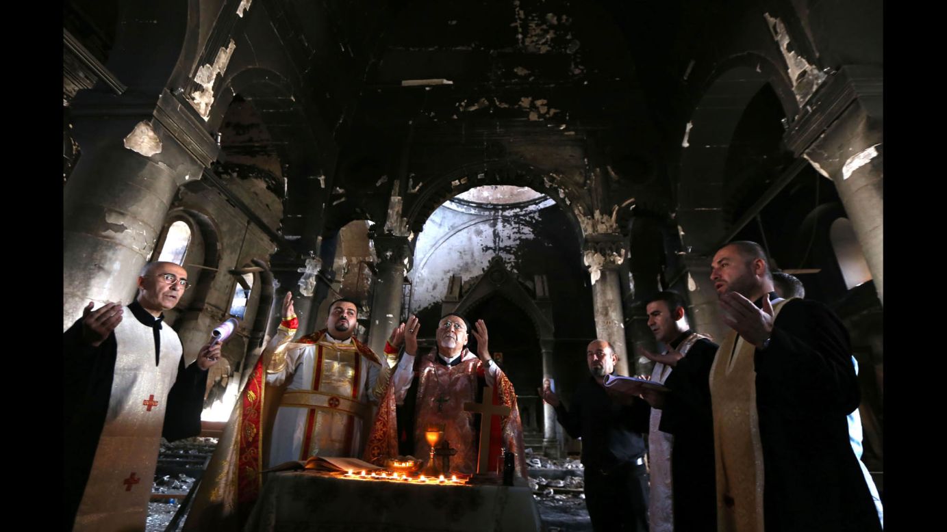 Archbishop Yohanna Petros Mouche, center, performs Mass in the liberated town of Qaraqosh on Sunday, October 30.