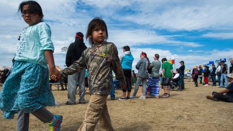 Two children walk together in oil pipeline protest encampment near Cannon Ball, North Dakota.