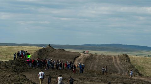 Native American protestors and supporters walk along land being prepared for the Dakota Access Pipeline.