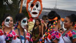 People in costume parade the annual Dia de los Muertos (Day of the Dead) festival at the Hollywood Forever cemetery in Hollywood, California on October 29, 2016.
Dia de los Muertos is a festival to remember friends and family members who have died and is celebrated throughout Mexico and by people of Mexican heritage living in the United States. / AFP / Mark RALSTON        (Photo credit should read MARK RALSTON/AFP/Getty Images)