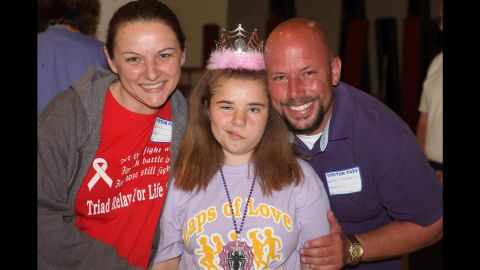 Bethany with her parents, Wendy Feucht and Paul Thompson, at the Relay for Life. Nerve damage from cancer treatment affected Bethany's smile.