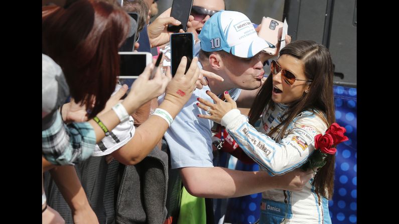 A fan tries to kiss NASCAR driver Danica Patrick during driver introductions in Martinsville, Virginia, on Sunday, October 30. 