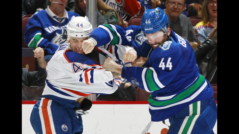 Edmonton's Zack Kassian, left, and Vancouver's Erik Gudbranson trade punches during an NHL game in Vancouver, British Columbia, on Friday, October 28.