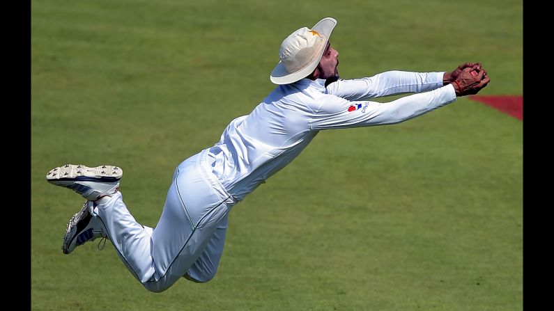 Pakistani cricketer Mohammad Amir catches a ball Monday, October 31, during a Test match against the West Indies in Sharjah, United Arab Emirates.