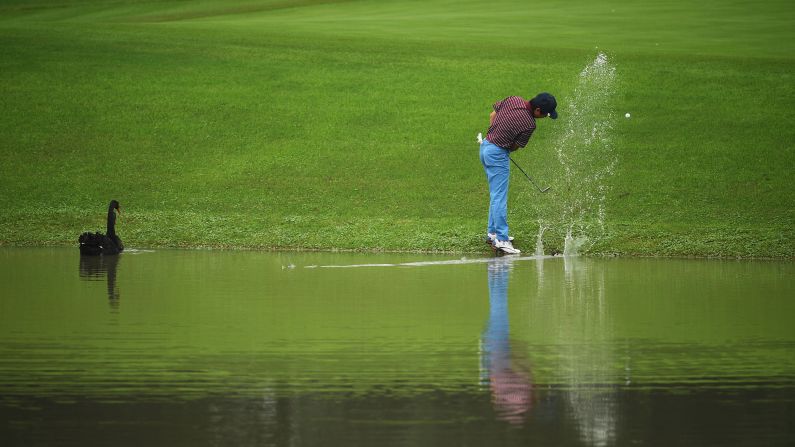 Xiong Zong hits his ball out of the water during a pro-am event in Shanghai, China, on Wednesday, October 26.