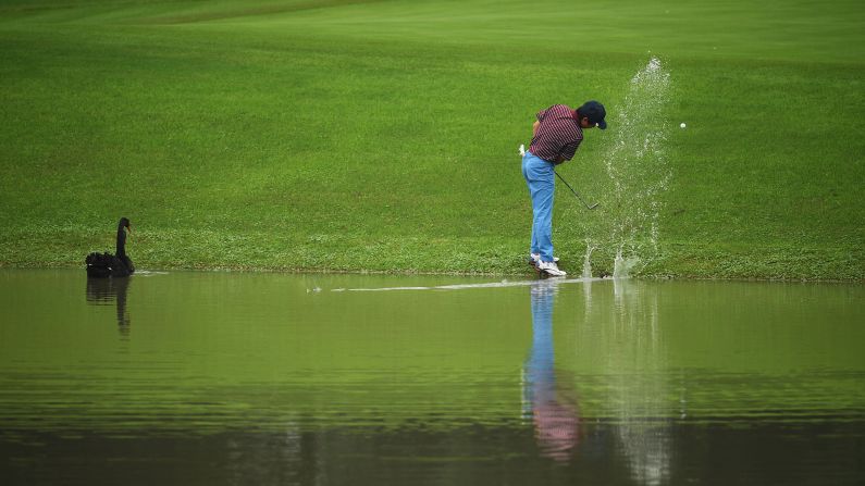 Xiong Zong hits his ball out of the water during a pro-am event in Shanghai, China, on Wednesday, October 26.