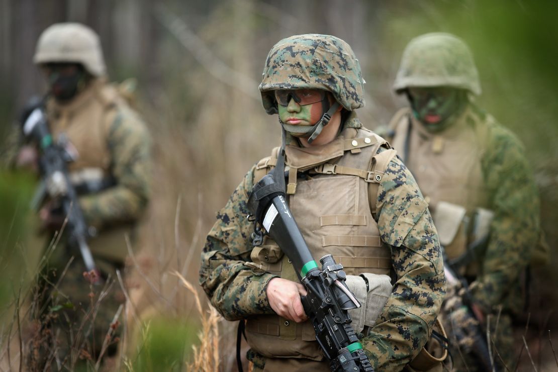 Pfc. Tiernie Gayle, center,  trains with male and female Marines at Camp Lejeune, North Carolina.  