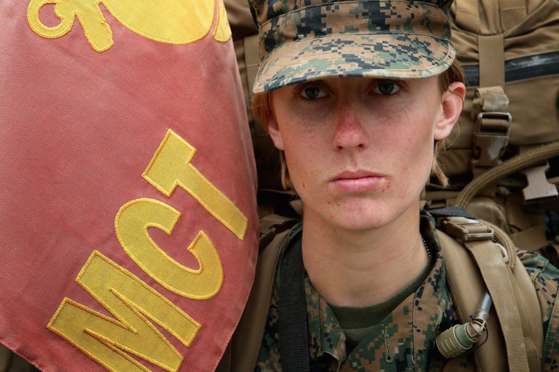 Pfc. Tiffany Mash leads a company of Marines carrying 55-pound packs at the start of a 10-kilometer training march in 2013 at Camp Lejeune, North Carolina.  