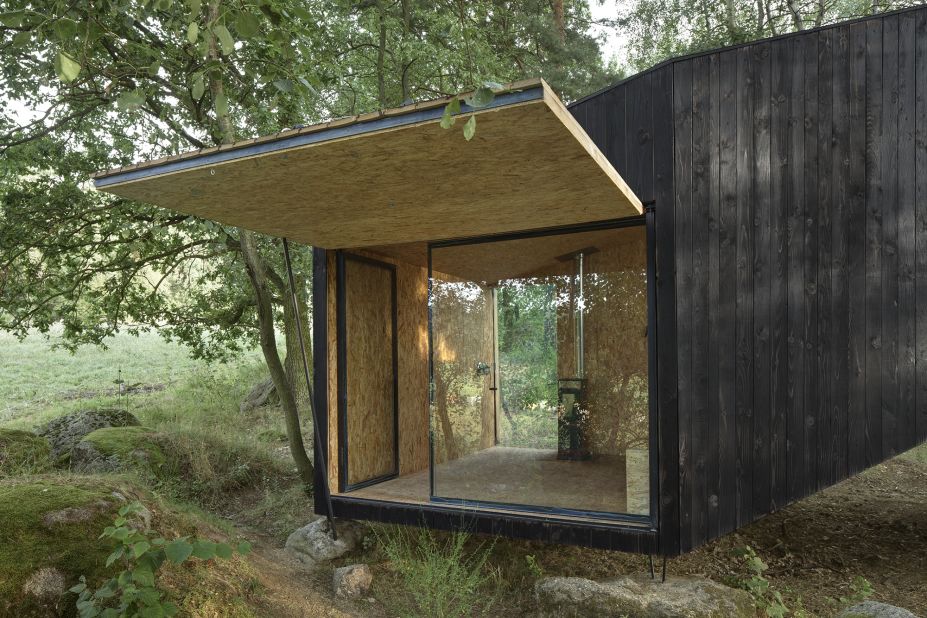 Uhlik Architekti used wood from a fallen tree to build the base of the Forest Retreat, which rests atop a nearby boulder in Central Bohemia, in Czech Republic. The 172-square-foot cottage features an entire wall of windows to make it feel as close to nature as possible. 