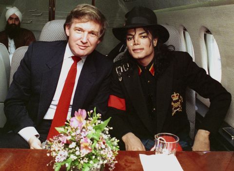 Trump and singer Michael Jackson pose for a photo before traveling to visit Ryan White, a young child with AIDS, in 1990.