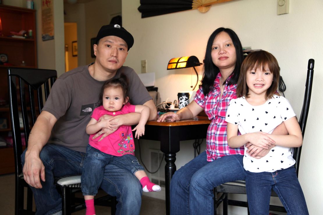 Korean adoptee Adam Crapser, left, with daughters, Christal and Christina and his wife, Anh Nguyen, in their Vancouver, Washington home. 