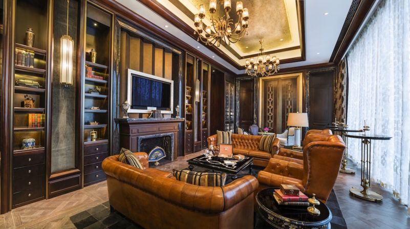 Chandeliers, leather sofas, thick carpets and mid-century furniture decorate the Wine & Cigar Bar of Club Reign, the property's exclusive members' club.