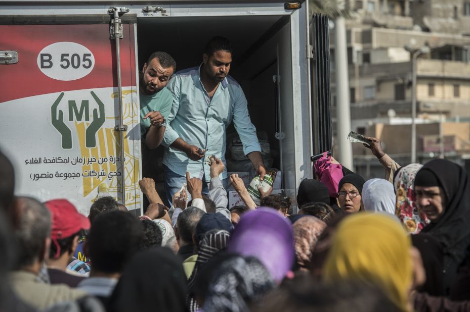 Crowds gather outside a distribution point of state-subsidized sugar in Cairo. 