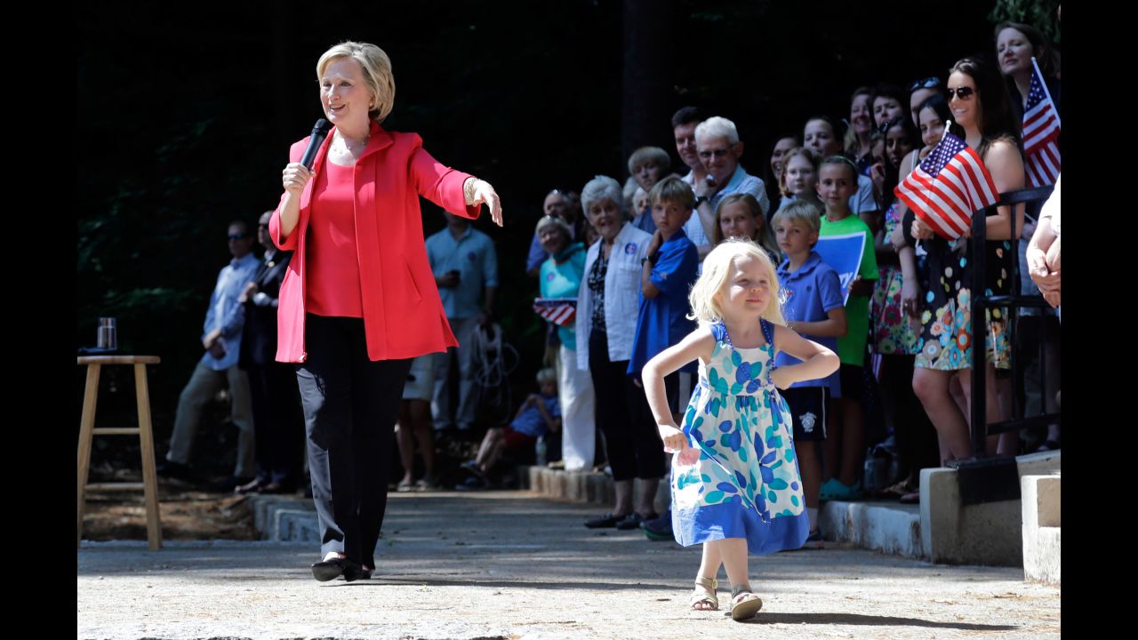 Louisa Hill, 3, walks onto a stage in Hanover, New Hampshire, as Clinton speaks on July 3, 2015.