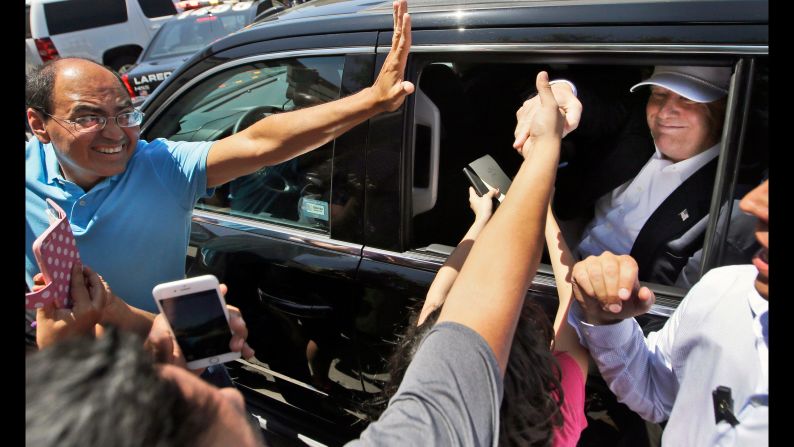 Supporters reach out to Trump as he leaves a stop in Laredo, Texas, on July 23, 2015. During <a href="index.php?page=&url=http%3A%2F%2Fwww.cnn.com%2F2015%2F07%2F23%2Fpolitics%2Fdonald-trump-border-visit-texas%2F" target="_blank">a four-hour visit,</a> Trump met with local officials and toured the border between the United States and Mexico. His visit was the culmination of more than a month of attention centered on Trump's branding of undocumented Mexican immigrants as killers and rapists -- remarks that drew condemnation from the Republican establishment but also helped rocket him to the top of the polls.