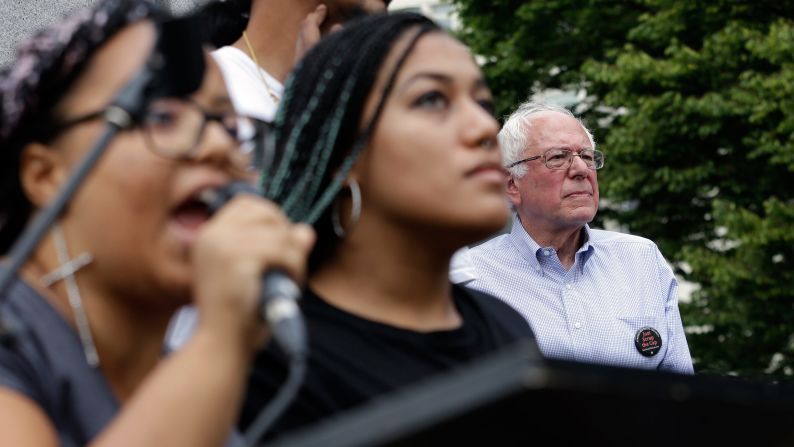 Seconds after Sanders took the stage for a rally in Seattle, a dozen protesters from the city's Black Lives Matter chapter <a href="index.php?page=&url=http%3A%2F%2Fwww.cnn.com%2F2015%2F08%2F08%2Fpolitics%2Fbernie-sanders-black-lives-matter-protesters%2F" target="_blank">jumped barricades and grabbed the microphone</a> on August 8, 2015. Holding a banner that said "Smash Racism," two of the protesters -- Marissa Johnson, left, and Mara Jacqueline Willaford -- addressed the crowd. Sanders stood just feet away off stage, chatting with his wife and the three aides that came to Seattle with him. His aides said the senator had no plans of leaving during the protests, but once Johnson did not appear willing to give up the mic after a moment of silence, organizers effectively shut down the event. Sanders never addressed the crowd, but he did make his way through it to shake hands and take pictures.